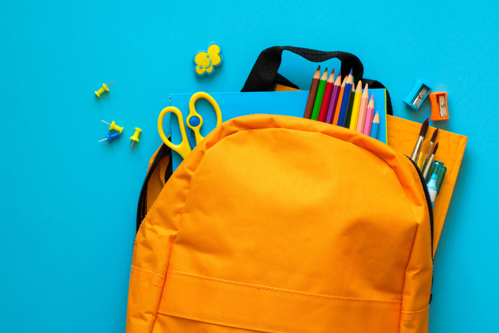 Back to school concept. Backpack with school supplies. Top view. Copy space